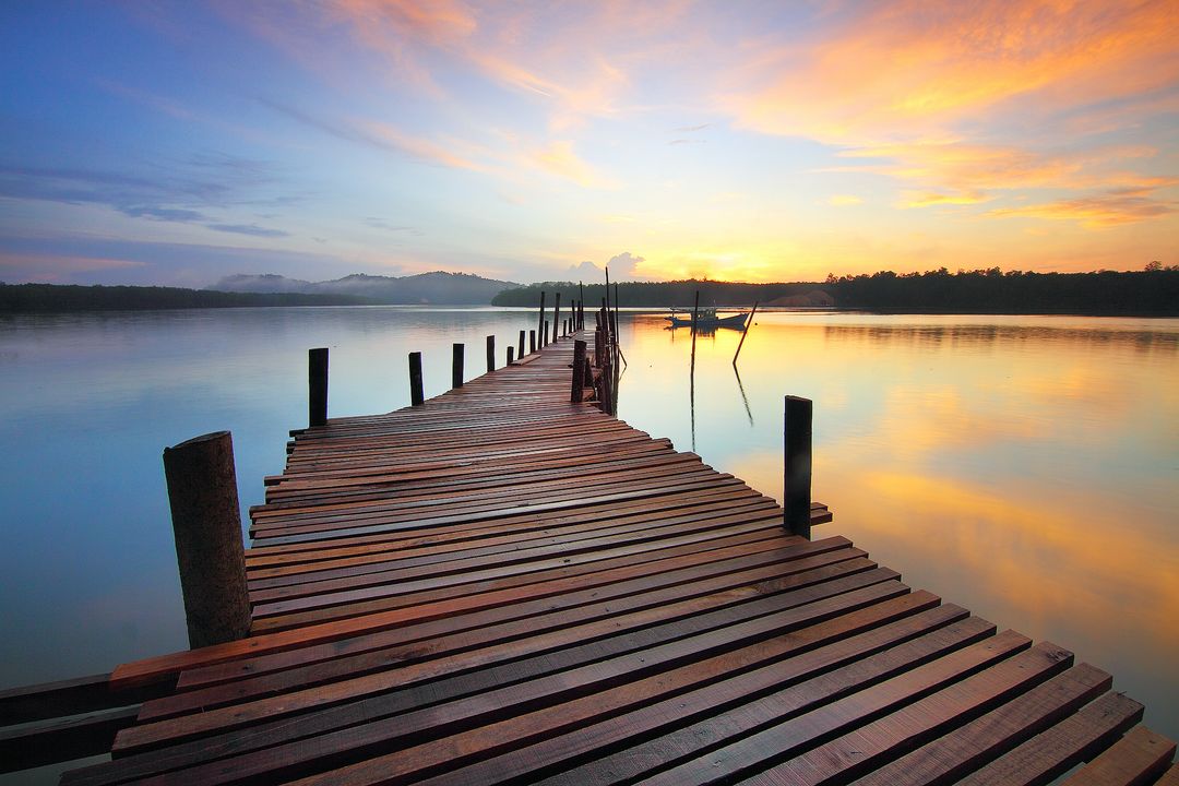 Old Wooden Pier Extending in Serene Lake at Sunrise - Free Images, Stock Photos and Pictures on Pikwizard.com