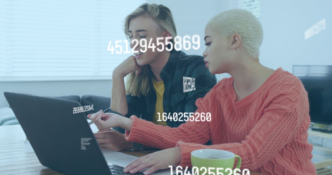 Diverse Female Colleagues Analyzing Data on Laptop