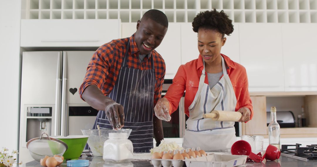 Image of happy african american couple baking together in kitchen - Free Images, Stock Photos and Pictures on Pikwizard.com