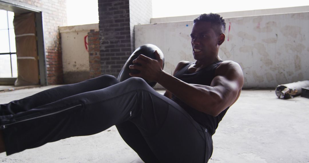 Muscular Man Exercising With Medicine Ball In Industrial Space - Free Images, Stock Photos and Pictures on Pikwizard.com