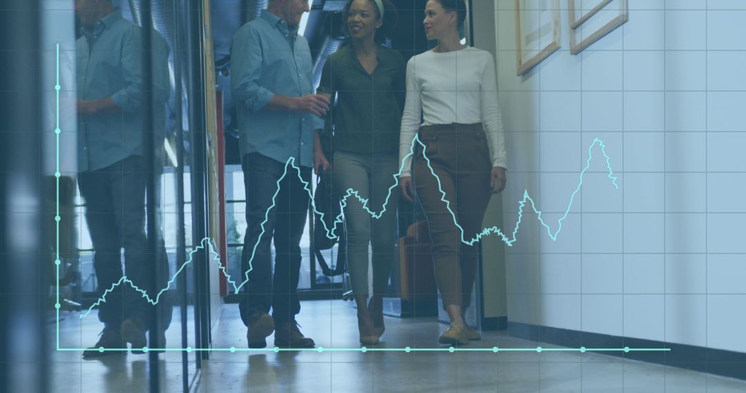 Happy Colleagues Walking through Office Corridor with Financial Graph Overlay - Free Images, Stock Photos and Pictures on Pikwizard.com