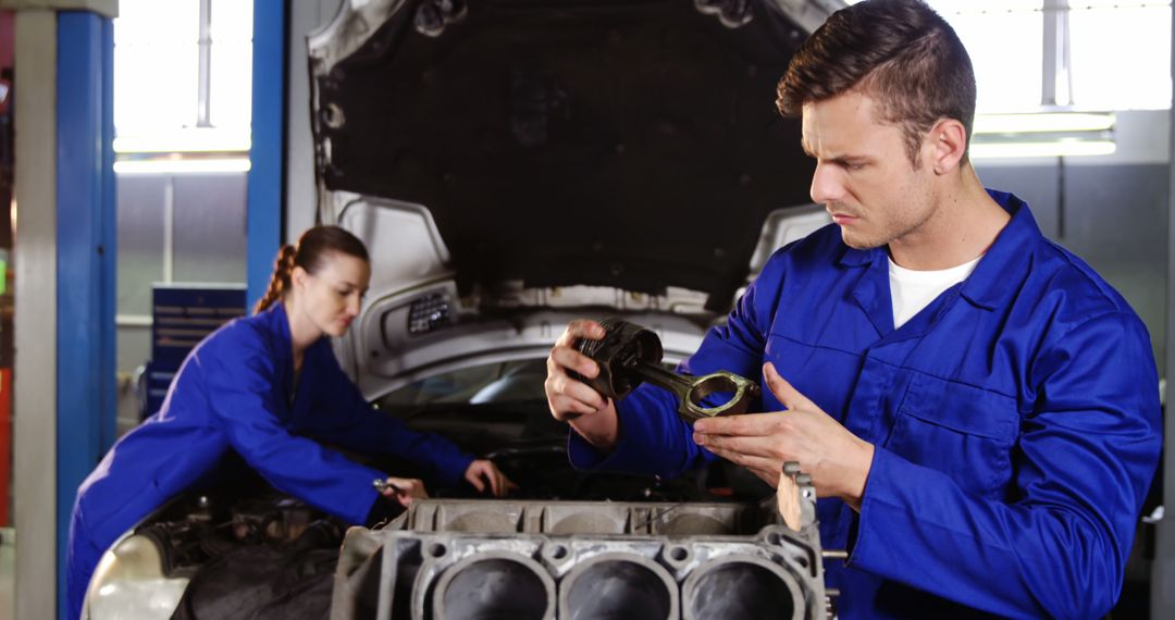 Auto Mechanics Working in Garage Inspecting Car Engine - Free Images, Stock Photos and Pictures on Pikwizard.com