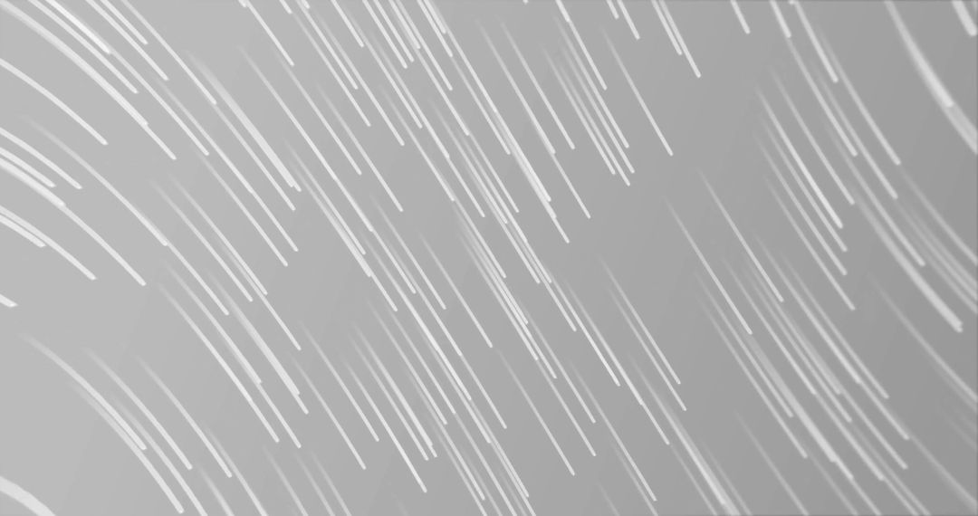 Glowing Light Trails Across Grey Background Creating Dynamic Movement