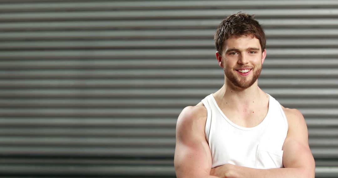 Young Muscular Man Smiling Indoors in Tank Top - Free Images, Stock Photos and Pictures on Pikwizard.com