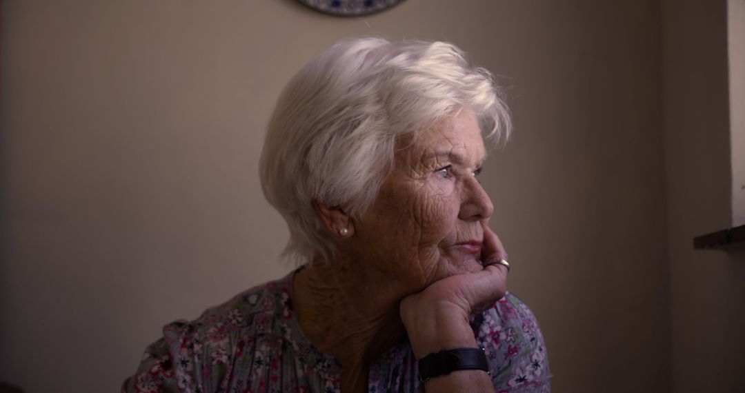 Senior Woman Reflecting in Soft Light at Home