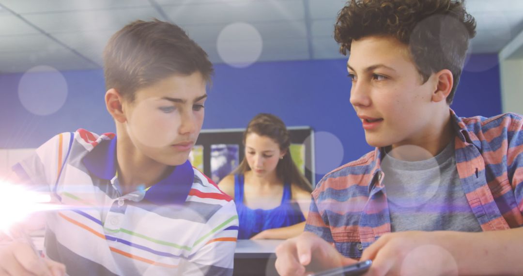 Teen Boys in Classroom Utilizing Smartphone with Colorful Bokeh Effect