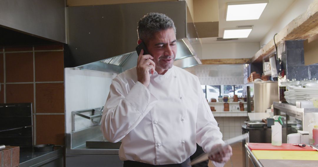 Chef Taking Phone Order in Commercial Kitchen - Free Images, Stock Photos and Pictures on Pikwizard.com