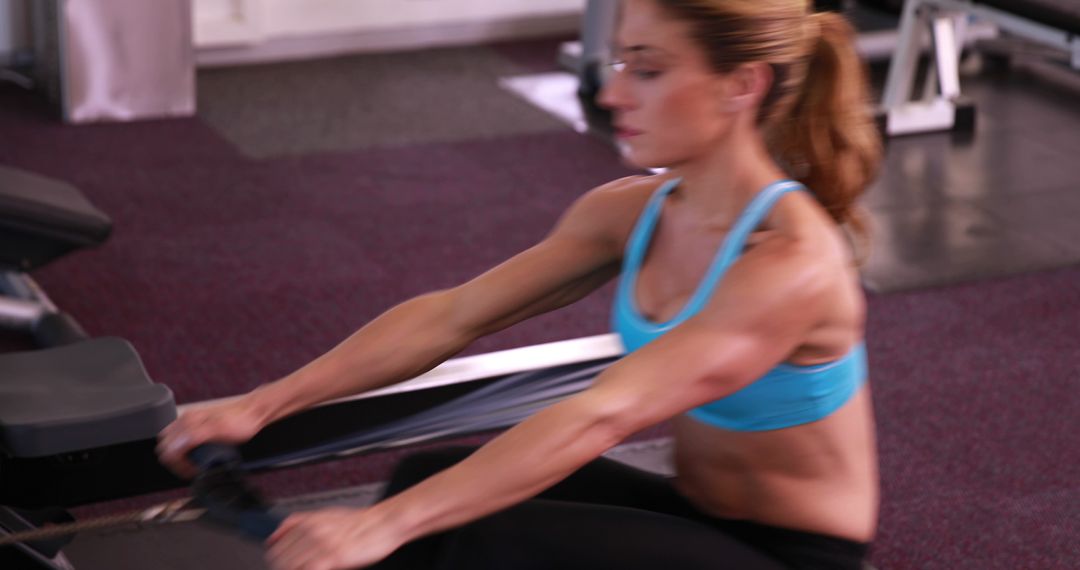 Focused Woman Exercising on Rowing Machine at Gym - Free Images, Stock Photos and Pictures on Pikwizard.com