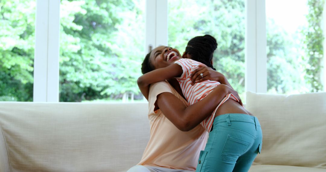 Two joyful African American women share a warm hug, symbolizing happiness and friendship. - Free Images, Stock Photos and Pictures on Pikwizard.com