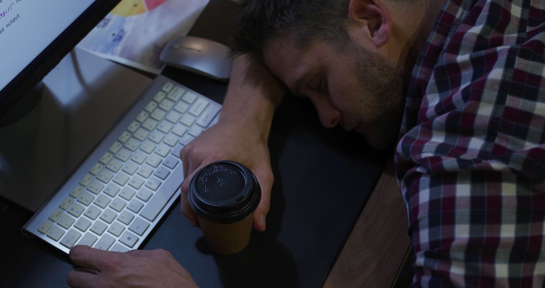 Tired man sleeping at desk with coffee and computer - Free Images, Stock Photos and Pictures on Pikwizard.com