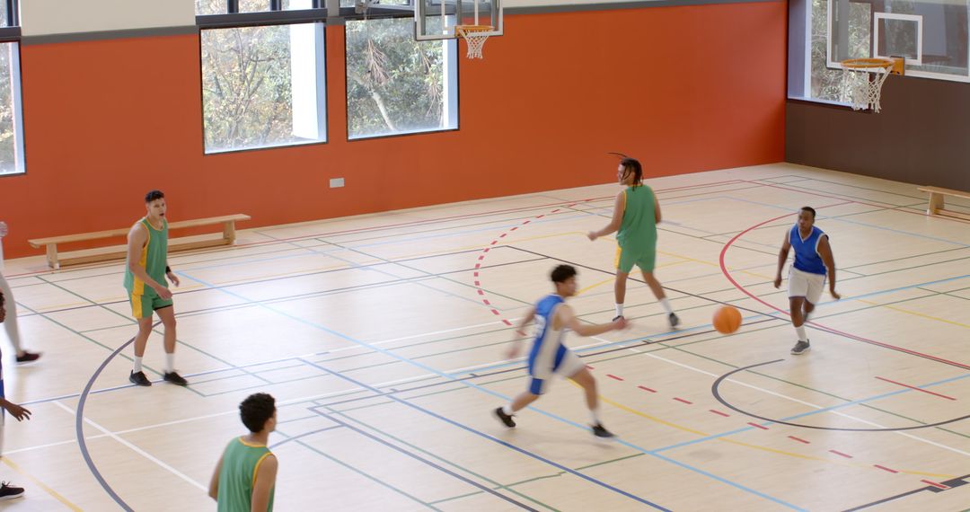 Basketball Players Competing Energetically in Gymnasium