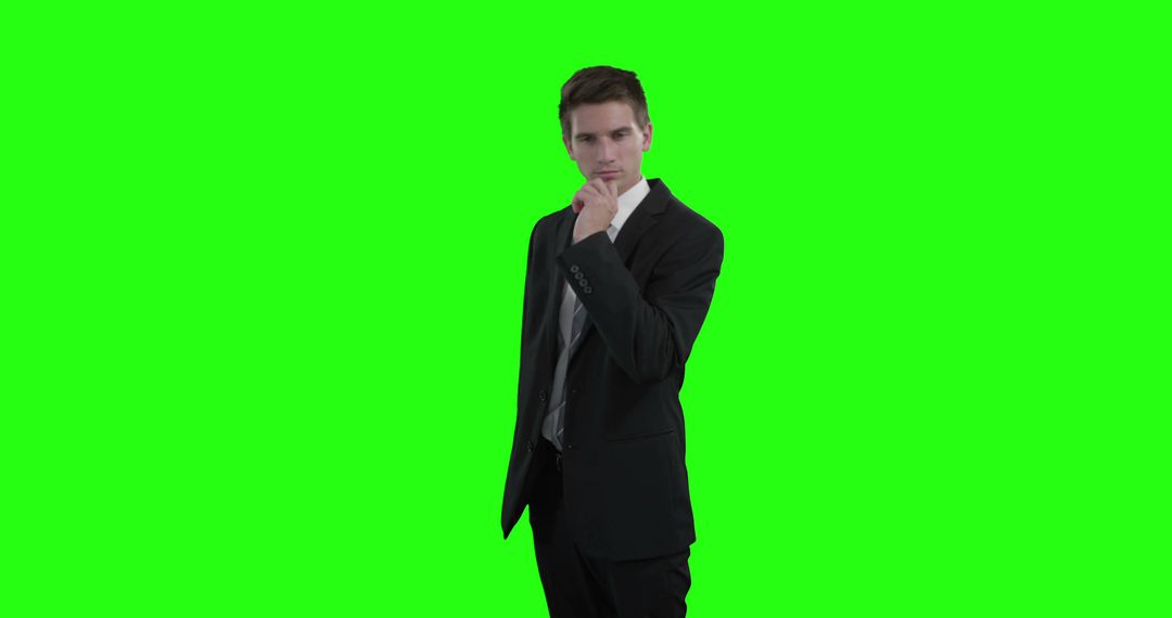 Businessman Contemplating in Business Suit with Green Screen Background - Free Images, Stock Photos and Pictures on Pikwizard.com