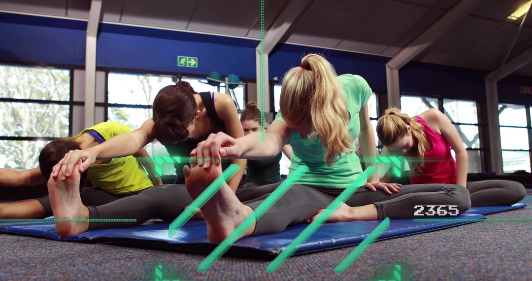 Women stretching in group fitness class with augmented reality performance overlay