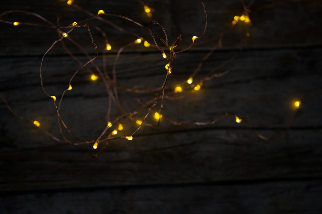 Warm Yellow Fairy Lights on Rustic Wooden Background - Free Images, Stock Photos and Pictures on Pikwizard.com