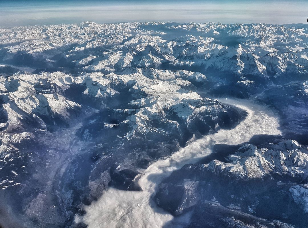 Aerial View of Snow-Capped Mountain Range with River Valley - Free Images, Stock Photos and Pictures on Pikwizard.com