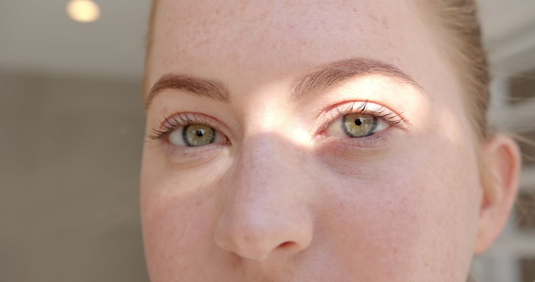 Close-up Portrait of Woman with Green Eyes and Freckles in Natural Light