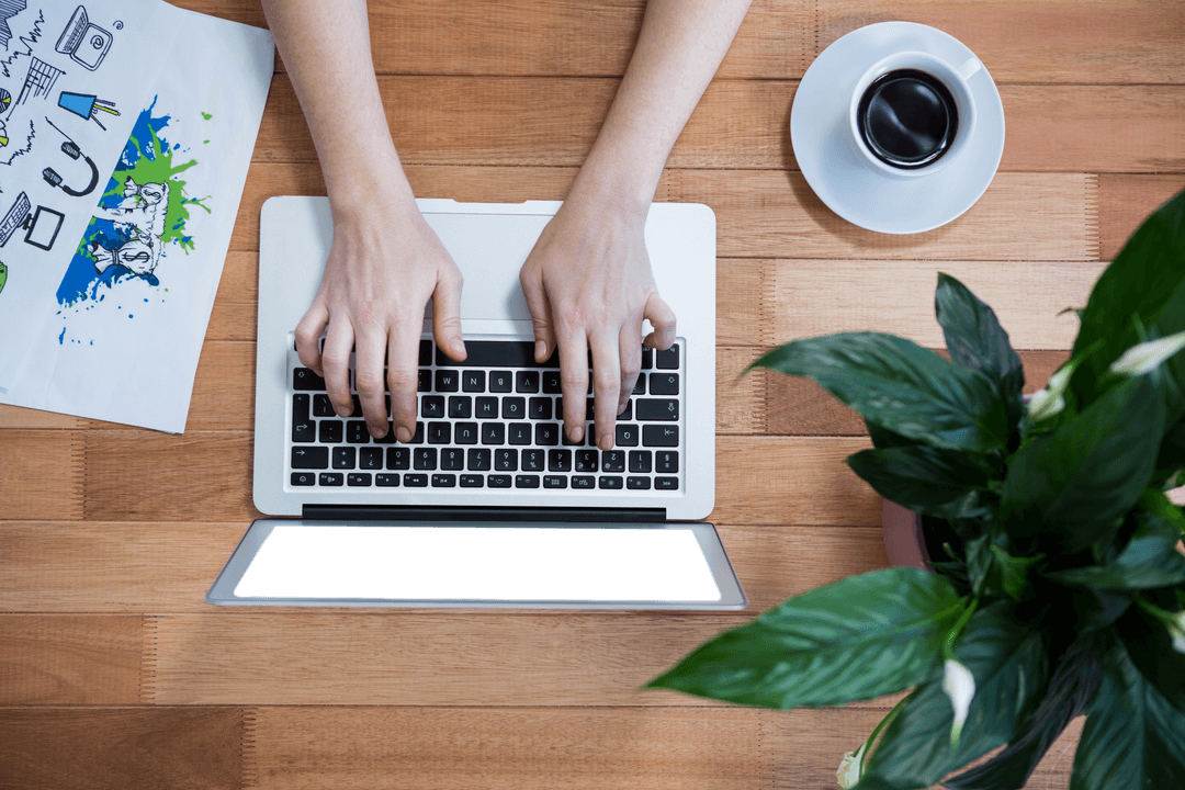 Transparent Overhead View of Typing on Laptop on Wooden Desk