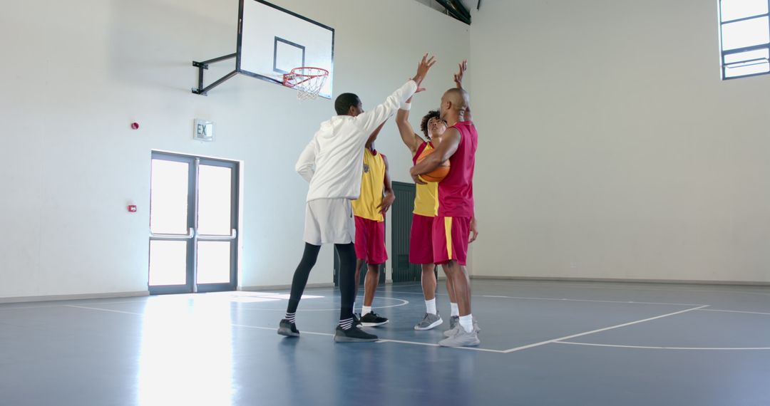 Diverse Basketball Team Strategizing During Practice