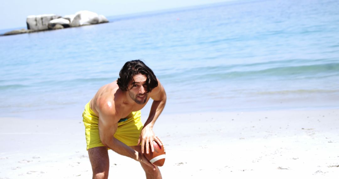 Active Young Man Playing Football on Sunny Beach - Free Images, Stock Photos and Pictures on Pikwizard.com