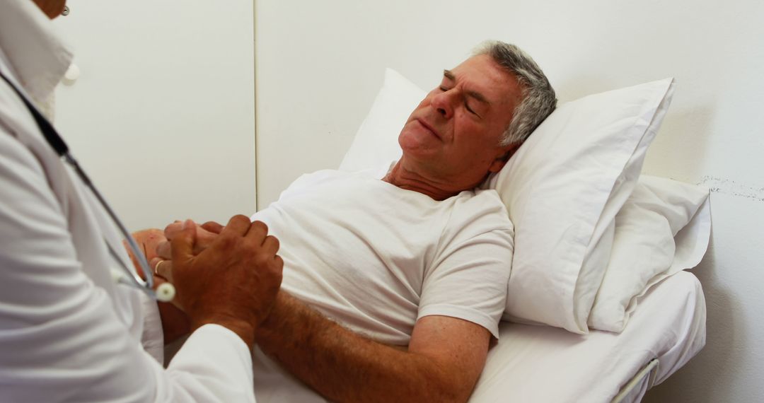 Doctor Monitoring Senior Patient Resting in Hospital Bed - Free Images, Stock Photos and Pictures on Pikwizard.com