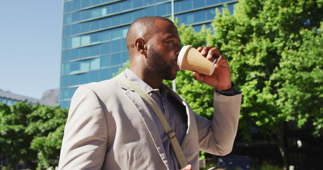 Business Professional Drinking Coffee Using Smartphone in Urban Setting