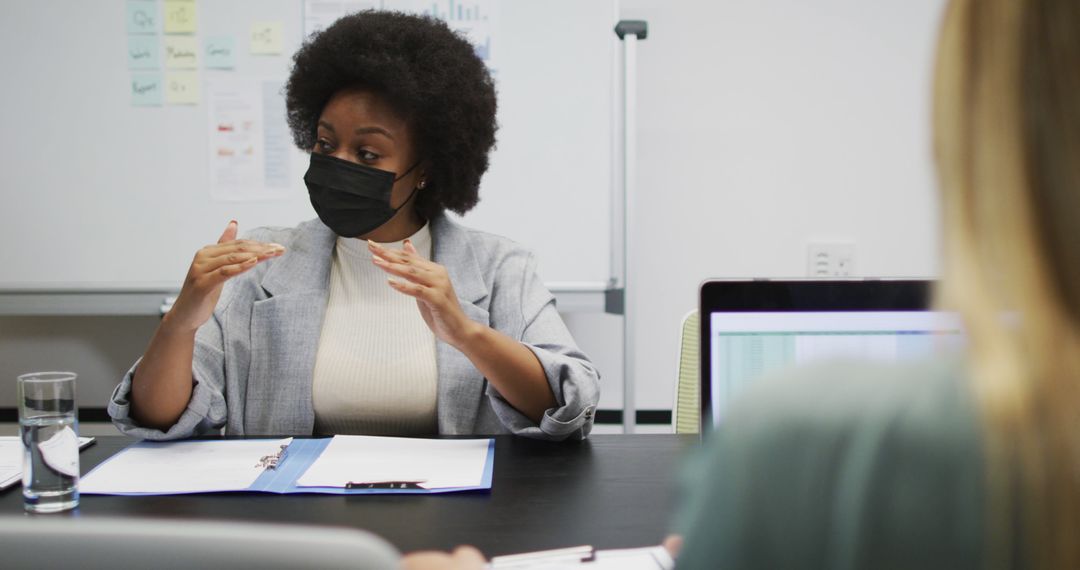 Businesswoman Wearing Mask Having Meeting in Office - Free Images, Stock Photos and Pictures on Pikwizard.com