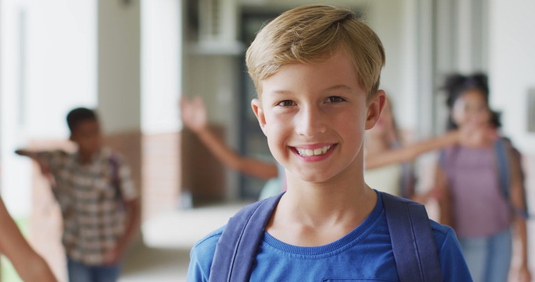 Image of happy caucasian boy standing at school corridor - Free Images, Stock Photos and Pictures on Pikwizard.com