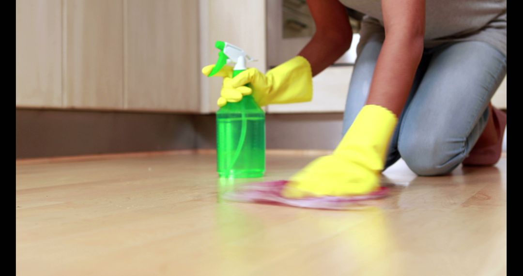 Person Cleaning Floor with Spray Bottle and Cloth - Free Images, Stock Photos and Pictures on Pikwizard.com