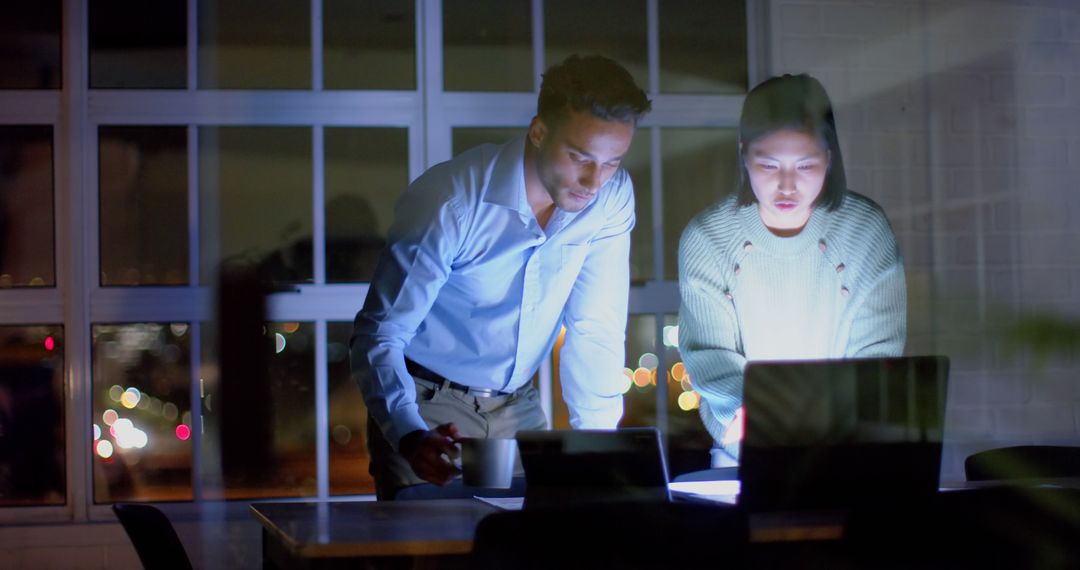 Diverse Team Collaborating on Late Night Project in Office