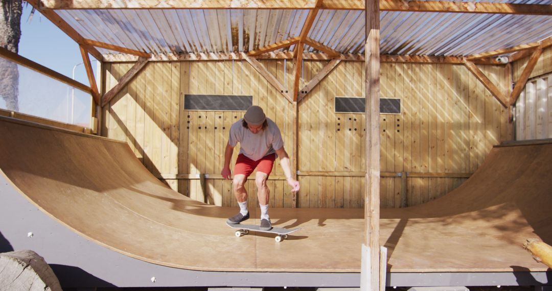 Skateboarder Performing Trick on Indoor Skate Ramp - Free Images, Stock Photos and Pictures on Pikwizard.com