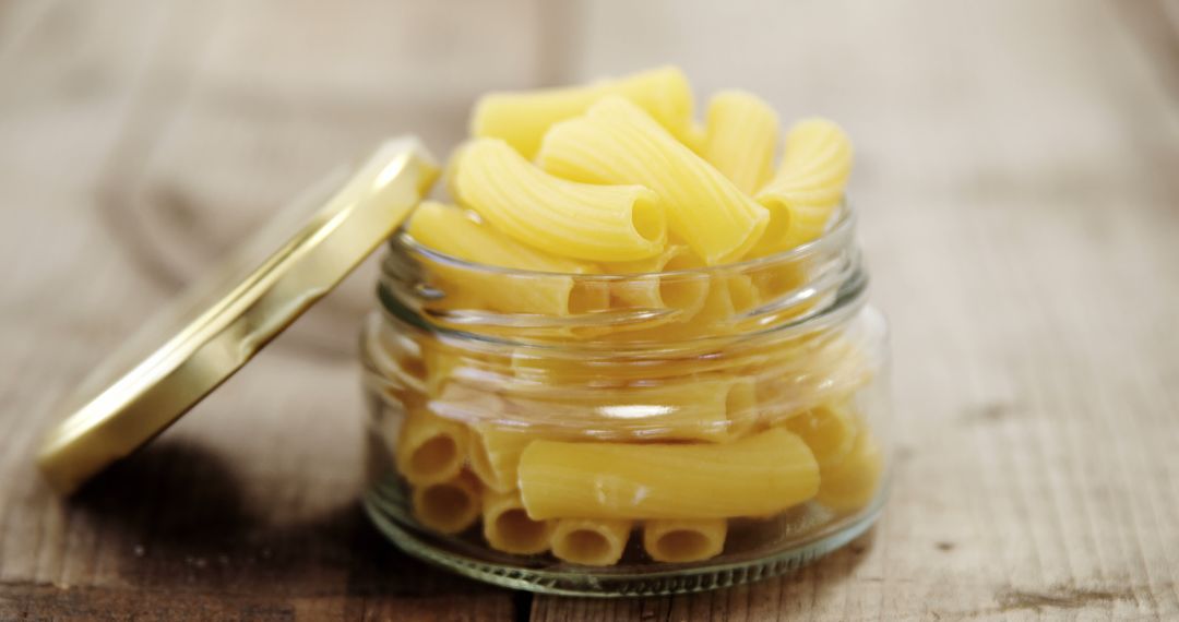 Uncooked Rigatoni Pasta in Glass Jar on Wooden Surface - Free Images, Stock Photos and Pictures on Pikwizard.com