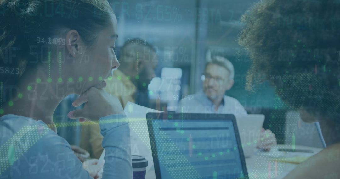 Business Team Analyzing Financial Data on Laptops in Modern Office