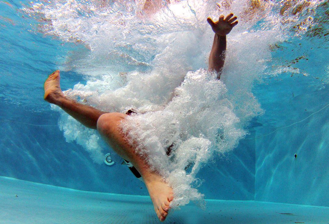 Person Splashes into Swimming Pool with High Energy and Joy - Free Images, Stock Photos and Pictures on Pikwizard.com