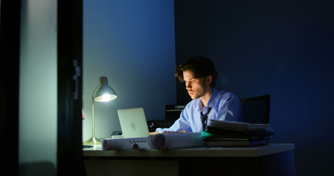 Late Night Working Professional Focused on Laptop at Desk - Free Images, Stock Photos and Pictures on Pikwizard.com