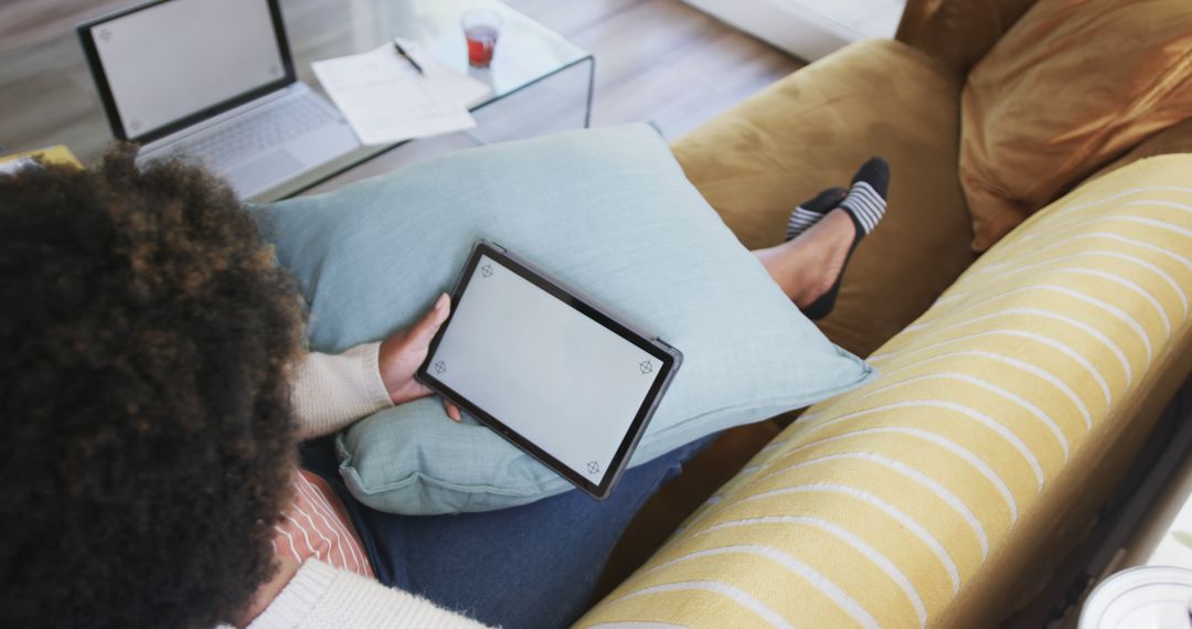 Woman Using Digital Tablet on Comfy Sofa in Cozy Living Room - Free Images, Stock Photos and Pictures on Pikwizard.com