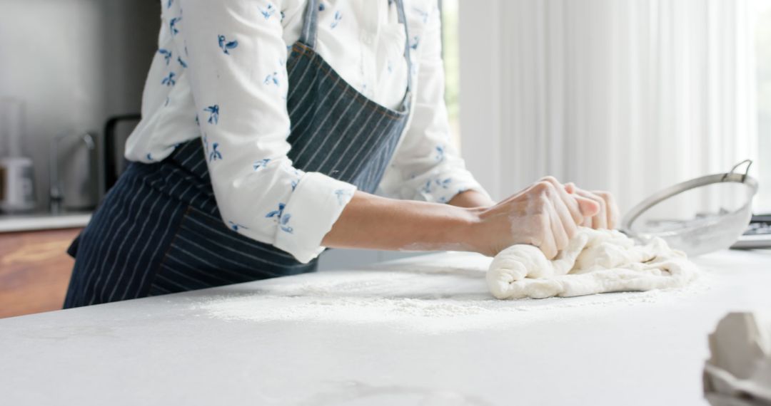 Woman Kneading Dough in Beautifully Lit Kitchen - Free Images, Stock Photos and Pictures on Pikwizard.com