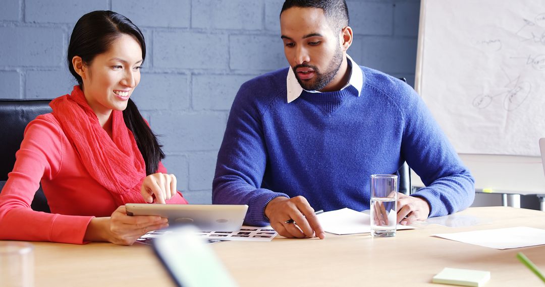 Diverse Professionals Collaborating on Digital Project in Office