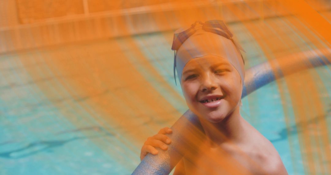 Smiling boy wearing swim cap and goggles leaning on pool handrail with orange mesh overlay