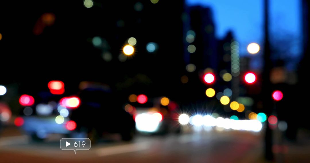 Blurred Cars and Bokeh Lights Illuminate Busy Downtown Street at Dusk