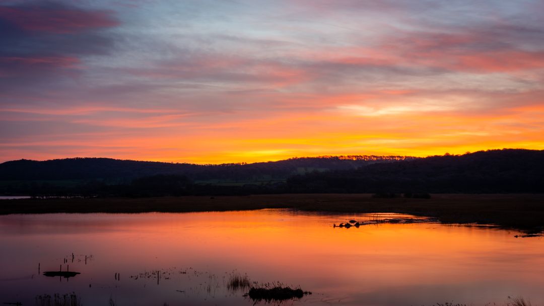 Serene Sunset Reflecting Over Tranquil Waterscape