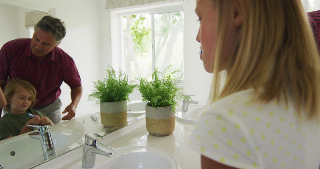 Father Teaching Daughter to Brush Teeth in Bright Bathroom - Free Images, Stock Photos and Pictures on Pikwizard.com