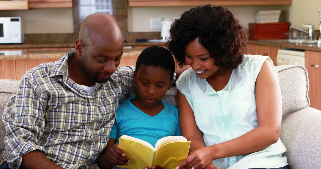 Loving African American Family Reading Storybook on Sofa - Free Images, Stock Photos and Pictures on Pikwizard.com