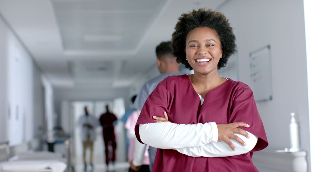 Confident Nurse Smiling in Hospital Hallway - Free Images, Stock Photos and Pictures on Pikwizard.com