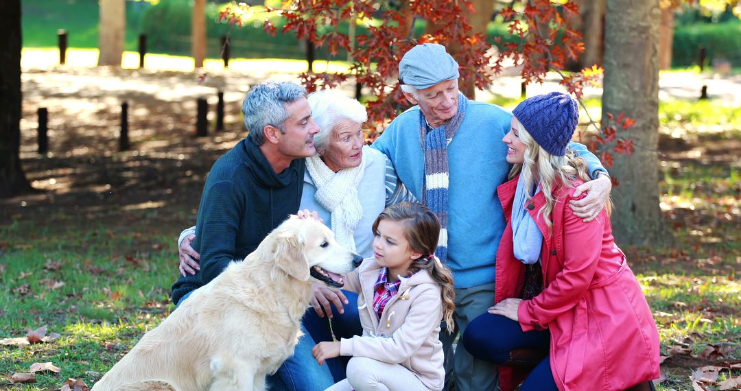 Multi-generational family enjoying park with pet golden retriever - Free Images, Stock Photos and Pictures on Pikwizard.com