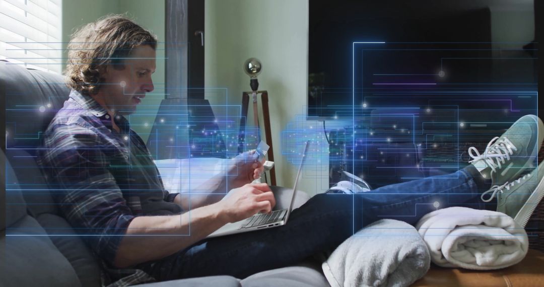 Man Using Laptop with Credit Card and Digital Circuitry Overlay