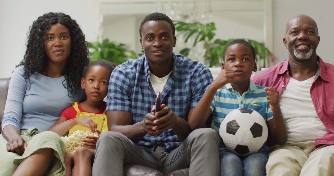 African American Family Watching Sports Game on Television at Home - Free Images, Stock Photos and Pictures on Pikwizard.com