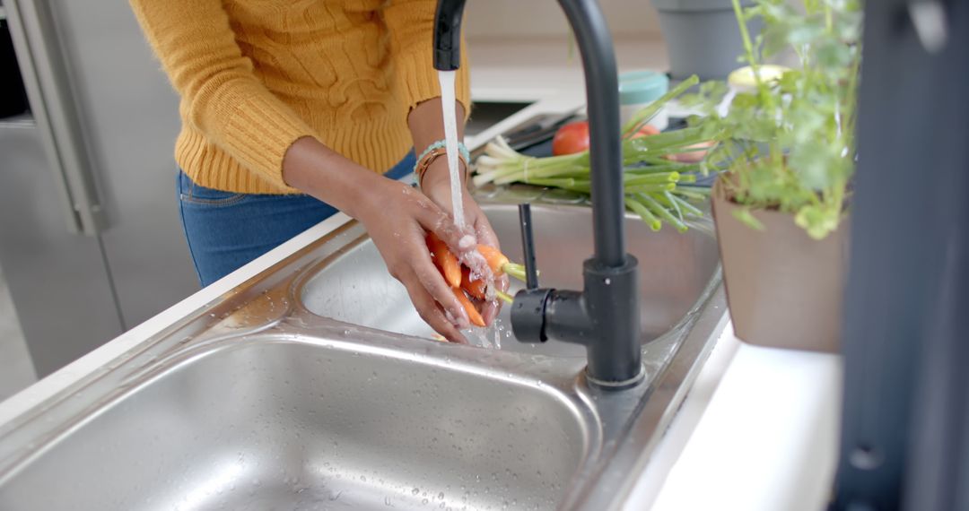 Woman Washing Fresh Vegetables Under Kitchen Tap - Free Images, Stock Photos and Pictures on Pikwizard.com