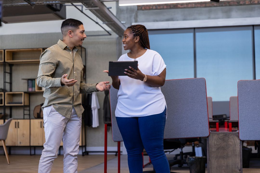 Diverse Coworkers Discussing Ideas in Modern Office Environment