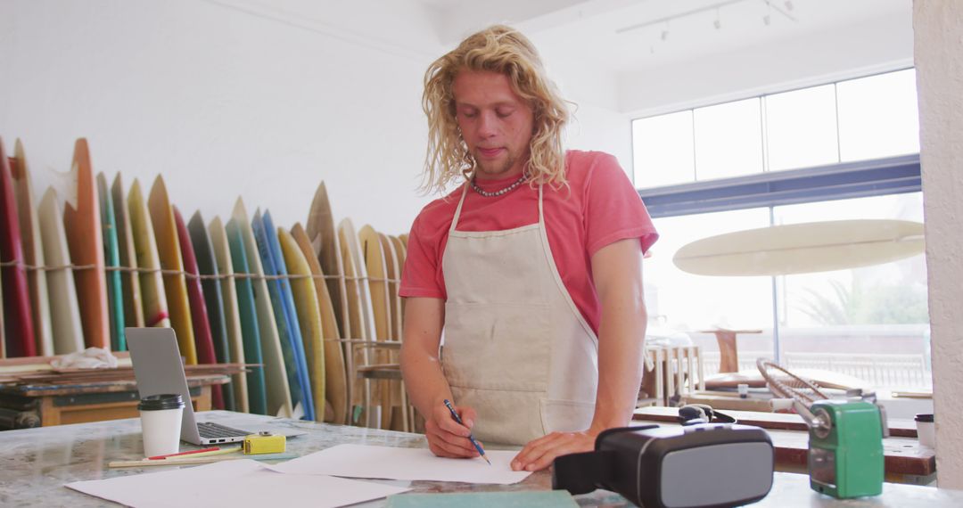 Blonde Artisan Designing Surfboards in Workshop - Free Images, Stock Photos and Pictures on Pikwizard.com