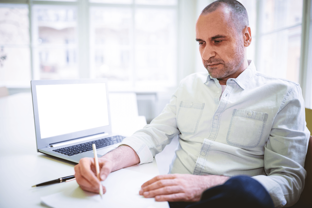 Thoughtful Professional Man Taking Notes in Office Setting